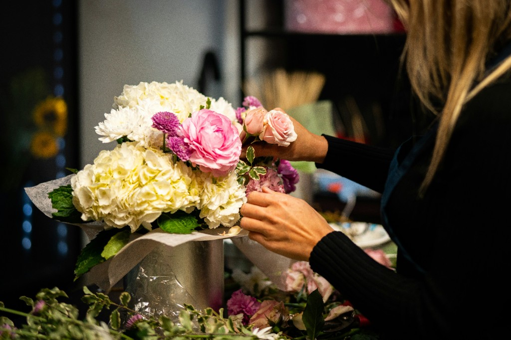 A florist arranging a bouquet — the kind of local business a good website should bring enquiries for